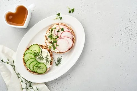 Two crispy buckwheat bread cake gluten free with cream cheese, red radish, cu Stock Photos