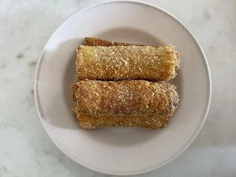 Two Crispy Fried Sausage Bread Rolls with Breadcrumbs on a White Plate Stock-Fotos