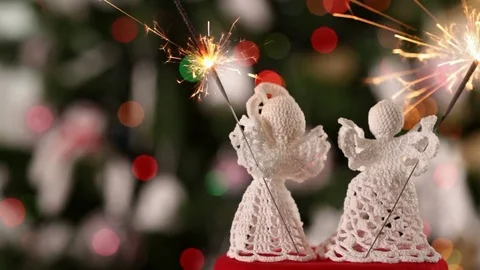 Two crocheted xmas angel decorations holding christmas sparklers Видео 81229099