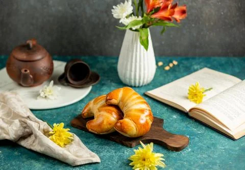 Two croissant-shape buns placed on wooden board Stock Photos