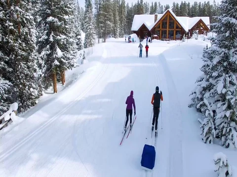 Two Cross Country skiers return to the Lodge Stock Footage 71892007