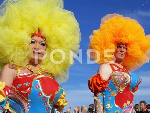 Two cross dressers in colorful costumes at Gay Pride parade. Stock Photos