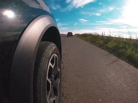 Two crossovers driving down the autumn road 스톡 동영상 163924514