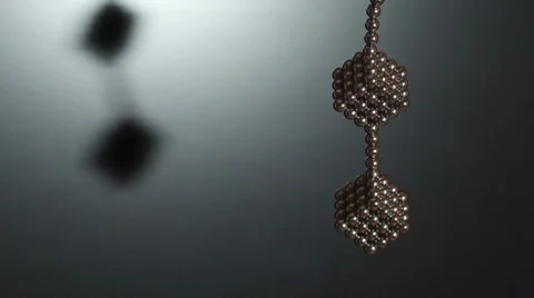 Two cubes compound of magnet spheres hangs on chain Video stock 8547891