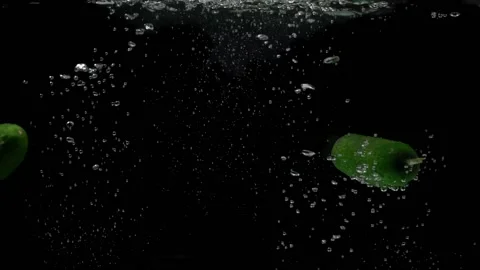 Two cucumbers fall into the water shooting underwater. Stock Footage 150120085