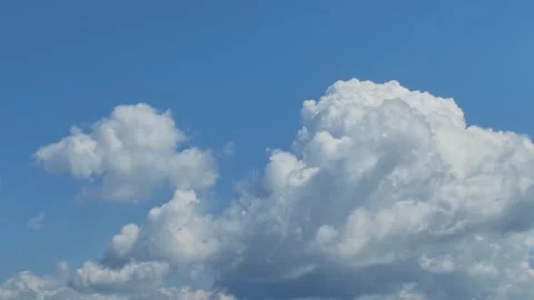 Two Cumulus Clouds of Different Sizes in Blue Sky Stock Footage 346734632