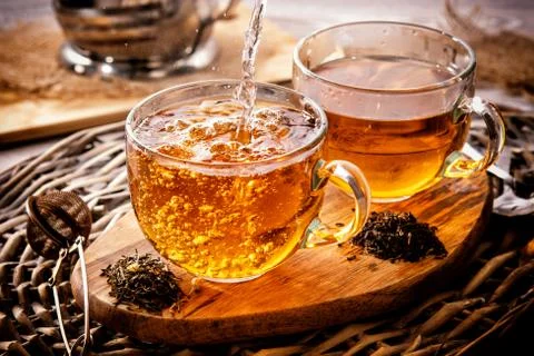 Two cups of black tea on a wicker table early in the morning. Tea morning at  Foto stock