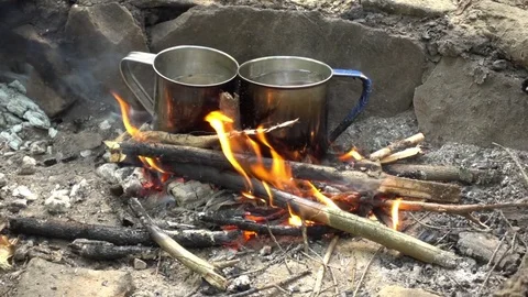 Two cups in bonfire Stock Footage 77486209