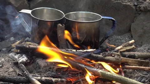 Two cups in bonfire Stock Footage 77488279
