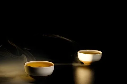 Two cups of chinese tea  with steam isolated on black background. Top view Stock Photos