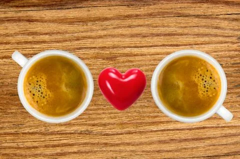 Two cups of coffee and red heart on wooden table, top view Stock Photos