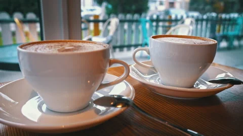 Two Cups of Coffee are on the Table in the Coffee Shop Stock Footage 229531380