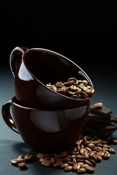 Two cups with coffee beans. Stock Photos