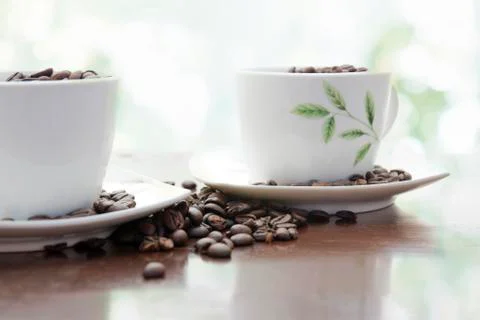 Two cups of coffee beans Stock Photos