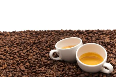 Two cups on coffee beans. Stock Photos