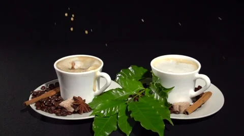 Two cups of coffee on a black background. A sugar cube falls in a cup of coffee. Stockbeeldmateriaal 61197597