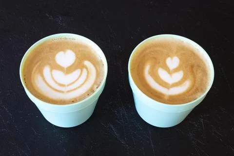 Two cups of coffee in black background Stock Photos