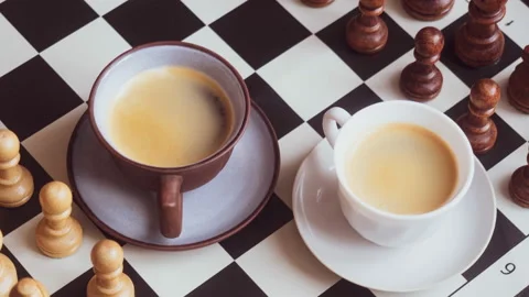 Two cups of coffee on a chessboard. The concept of morning ideas Stock Footage 161206079