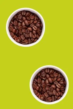 Two cups with coffee grains, flatlay, orange and lime background. Stock Photos