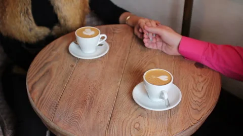 Two cups of coffee with a pattern on a table Video stock 68992519