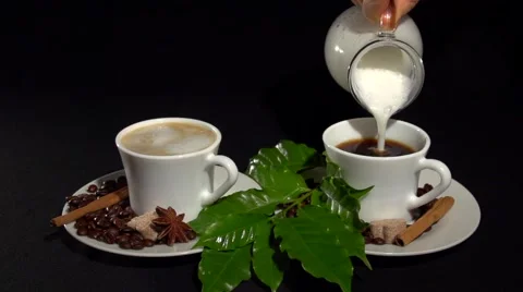 Two cups of coffee. Pouring milk into a cup of coffee. Stock-Footage 61197551
