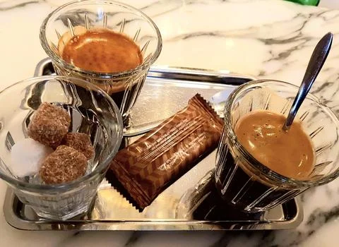 Two cups of coffee with sweets and chocolate Stock Photos