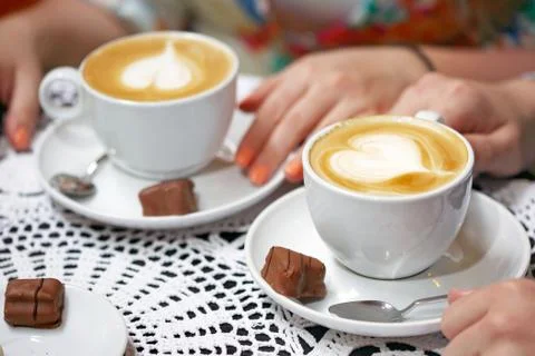 Two cups of coffee on a table, coffe and chocolate. Stock Photos