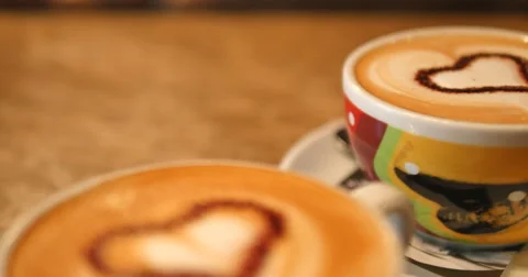 Two cups of coffee on the table, latte art Vídeos de archivo 65366078