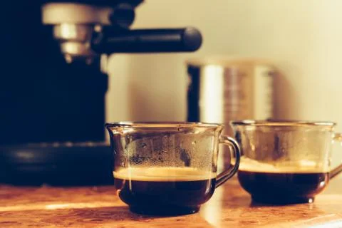 Two cups of coffee on the table near the coffee machine Stock Photos