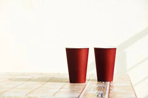 Two cups of coffee on a yellow table. Stock Photos