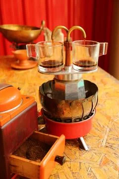 Two cups of espresso being brewed with a mini retro coffee maker 스톡 사진
