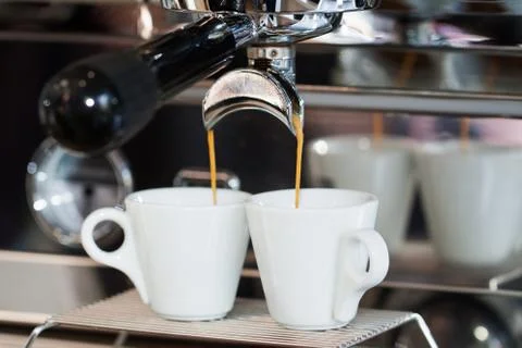 Two cups of espresso in the coffee machine Stock Photos