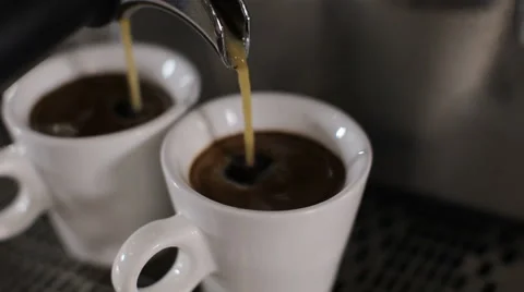 Two cups of espresso pour out. Close up 動画素材 63991161