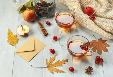 Two cups of fragrant tea with rose hips and spices on light boards, with a Stock Photos