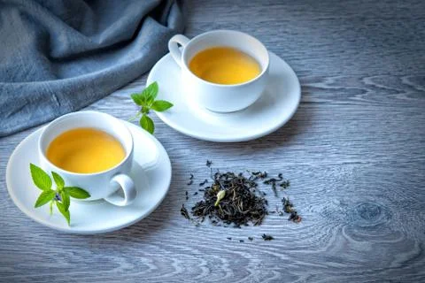 Two cups of green tea on a gray background Stock Photos