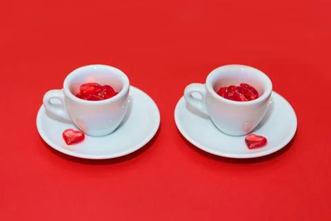 Two cups with hearts on a red background. the view from the top. red hearts s Stock Photos