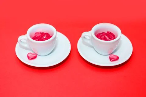 Two cups with hearts on a red background. the view from the top. red hearts s Stock Photos