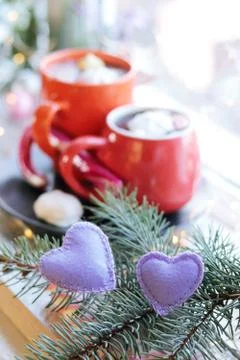 Two cups with a hot drink, marshmallows, caramel sticks, Christmas decor, hearts Stock Photos