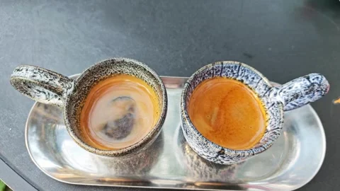 Two cups of hot espresso with thick crema on a metal tray. 스톡 동영상 339780498