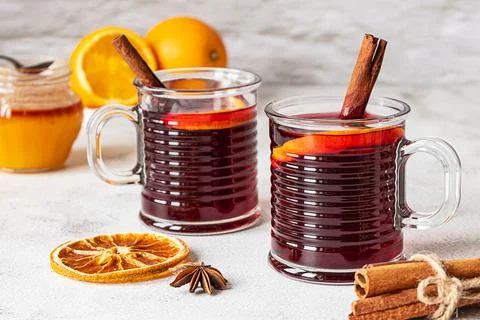 Two cups of hot mulled wine on a grey background Stock Photos
