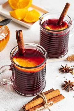 Two cups of hot mulled wine on a grey background Stock Photos
