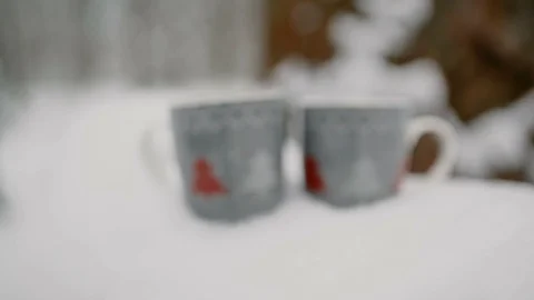 Two cups of hot tea, coffee or hot chocolate in the snow. close-up, 4к. Stock Footage 99201230