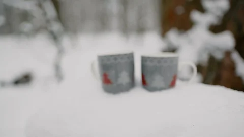 Two cups of hot tea, coffee or hot chocolate in the snow. close-up, 4к. Stock Footage 99204101