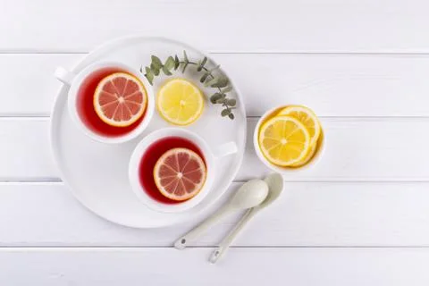 Two cups of red fruit and herbal tea with lemon slice, top view Stock Photos