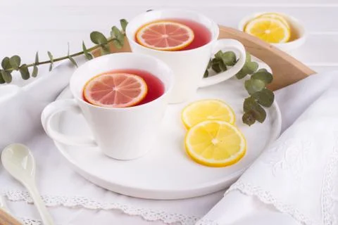 Two cups of red fruit and herbal tea with lemon slice Stock Photos