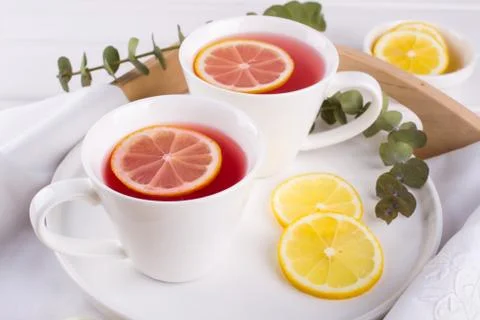 Two cups of red fruit and herbal tea with lemon slice, Stock Photos