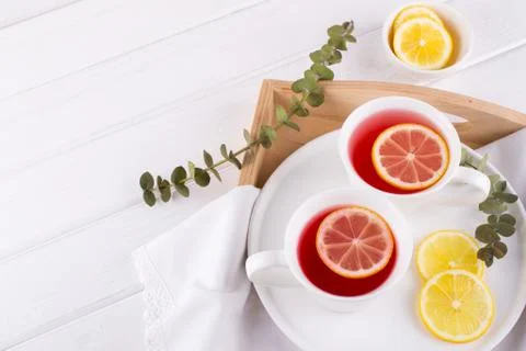 Two cups of red fruit and herbal tea with lemon slice, top view Stock Photos
