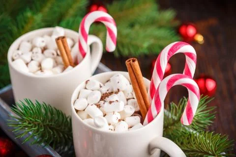 Two cups with small marshmallows on a dark wooden background Stock Photos