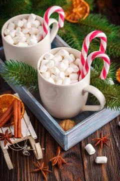 Two cups with small marshmallows on a dark wooden background Stock Photos