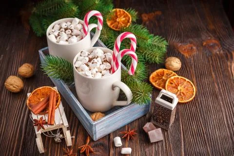Two cups with small marshmallows on a dark wooden background Stock Photos
